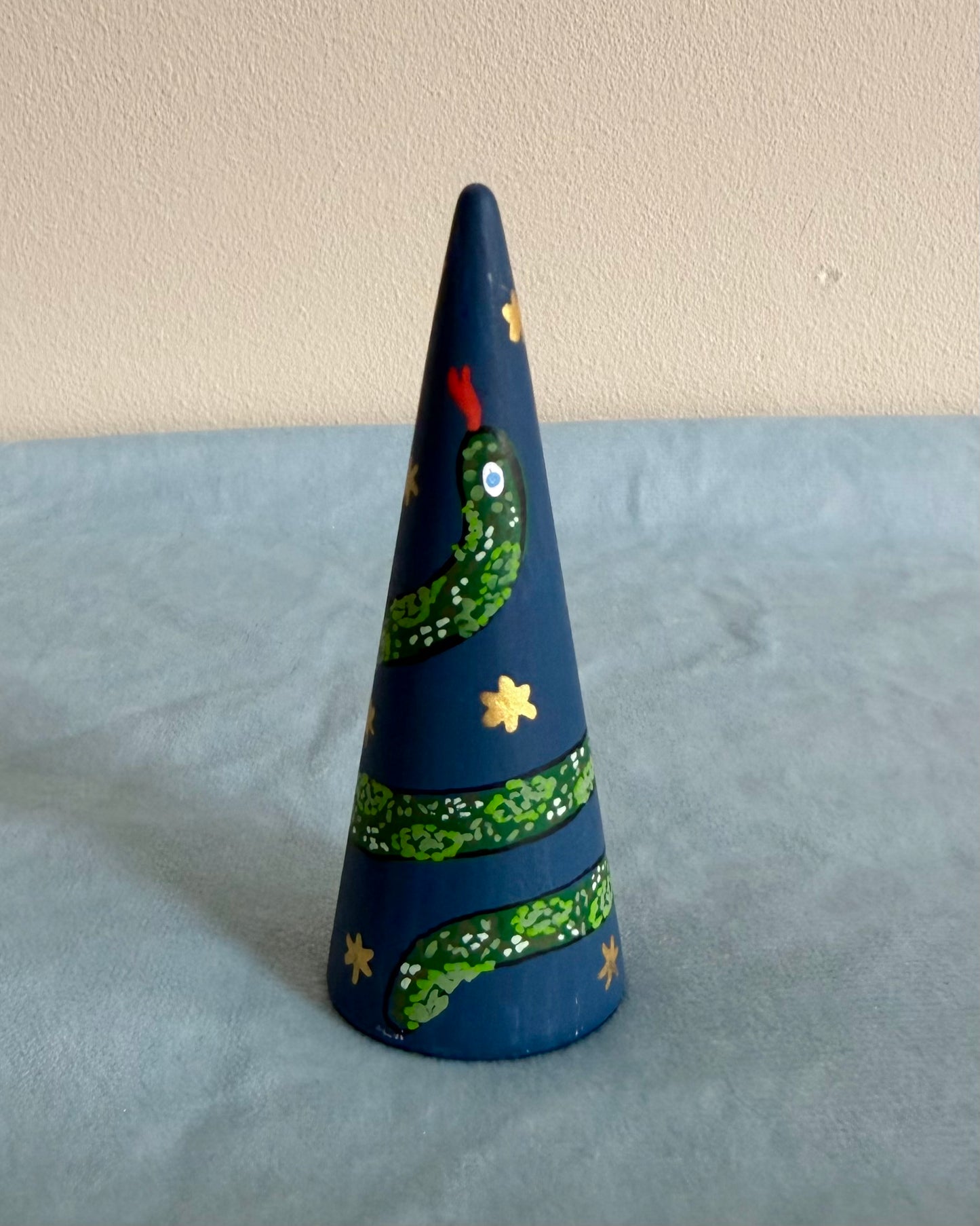 blue ringcone with vibrant green snake