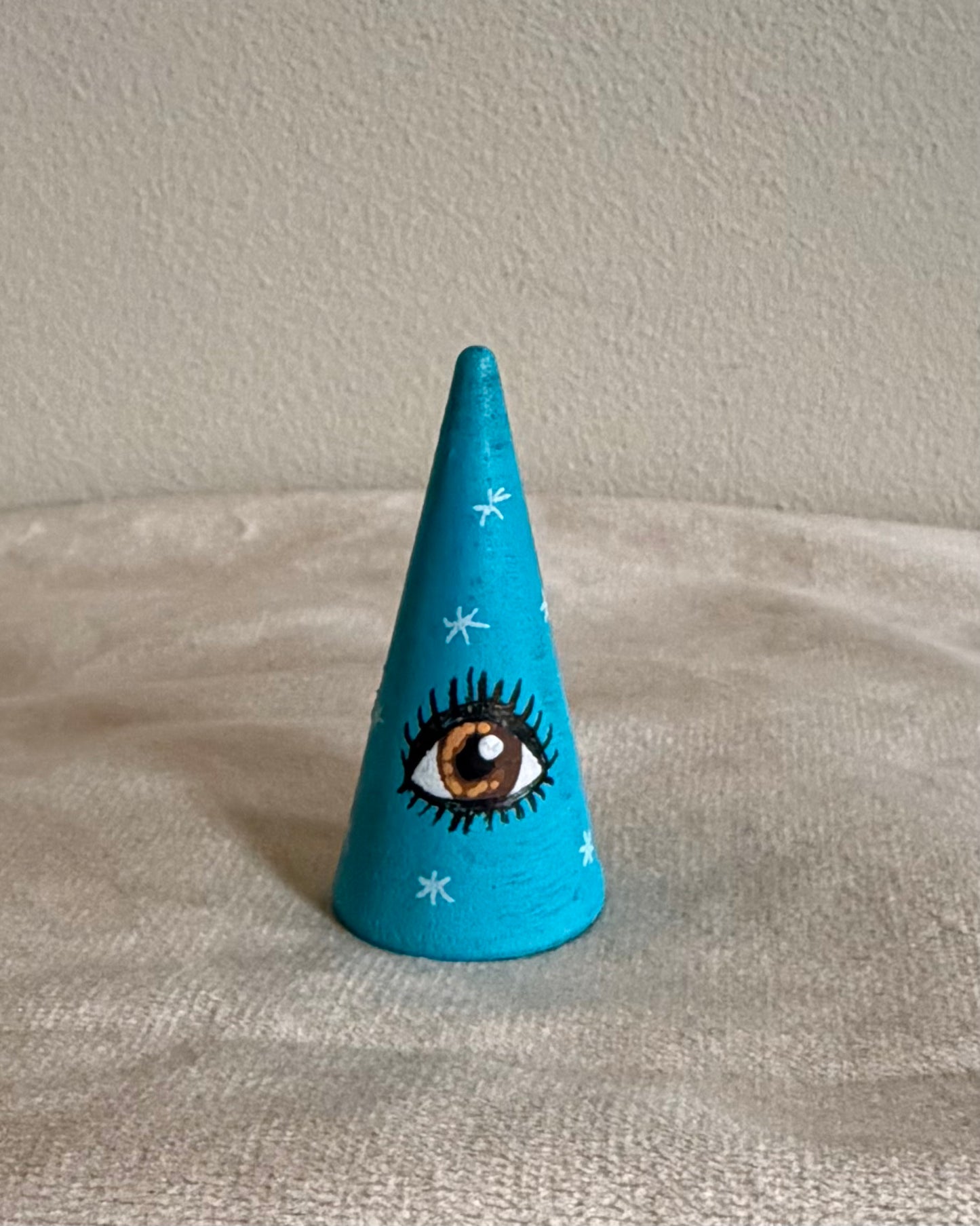 blue ringcone with lucky eye charm