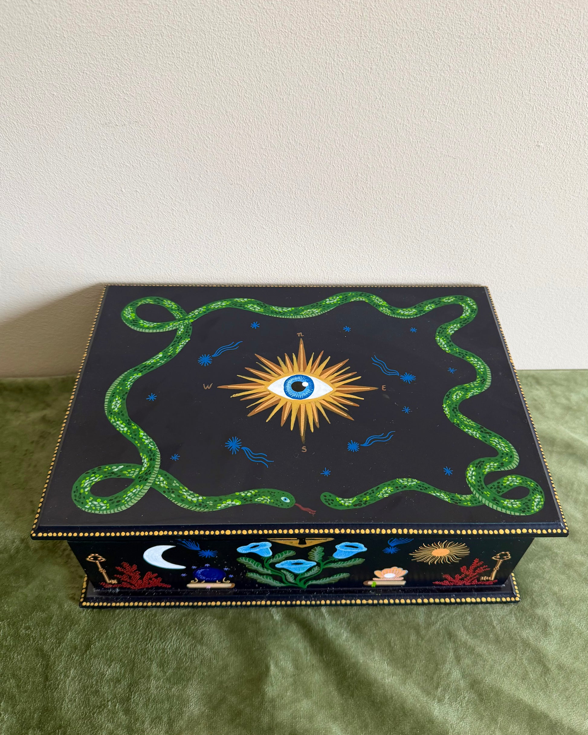 jewelrybox with vibrant green snake and eye illustrations