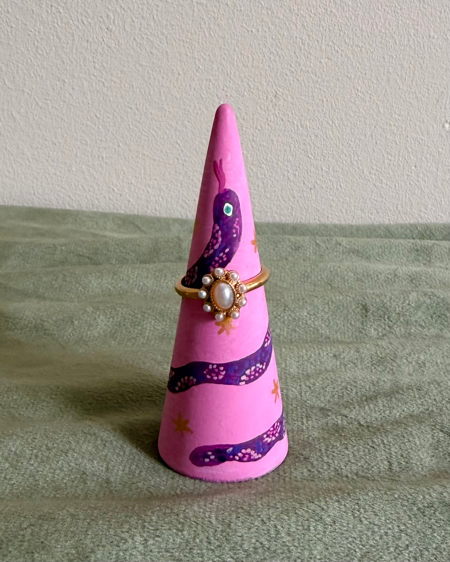 pink ringholder with detailed purple snake illustration
