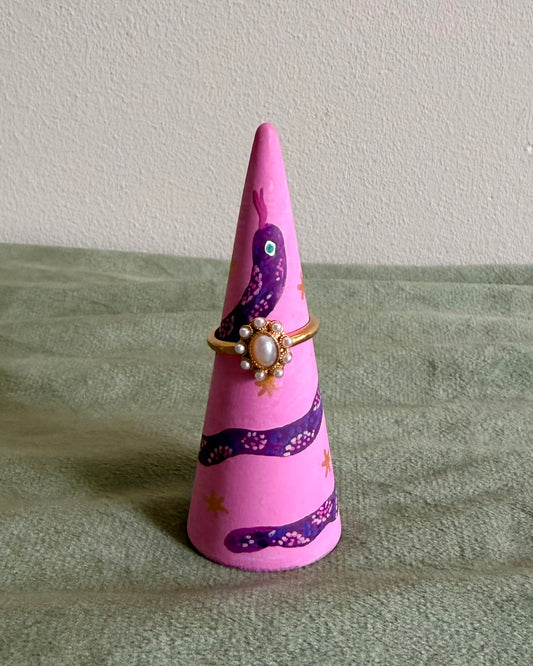 pink ringholder with detailed purple snake illustration