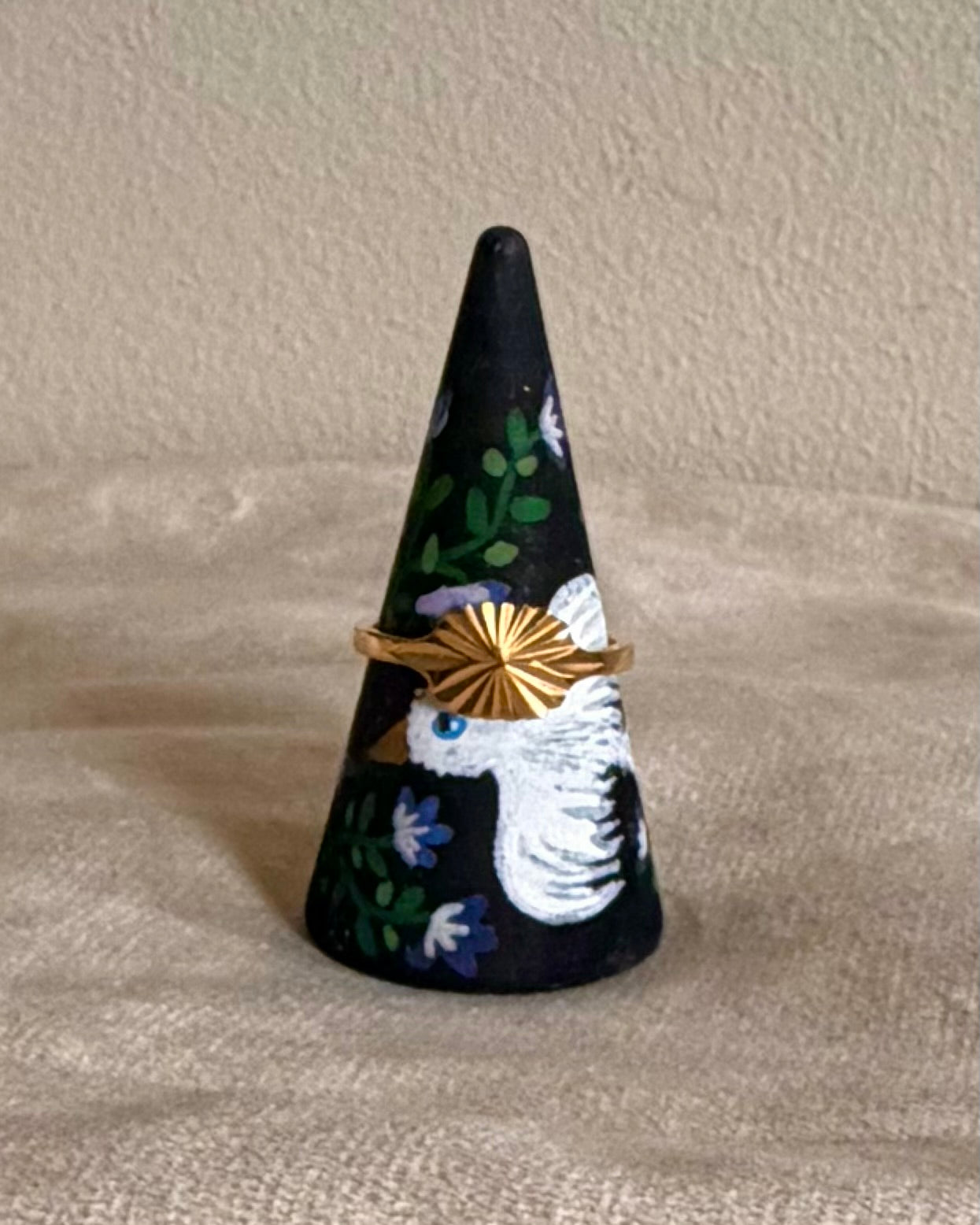 black ringcone with white bird and lilac flowers
