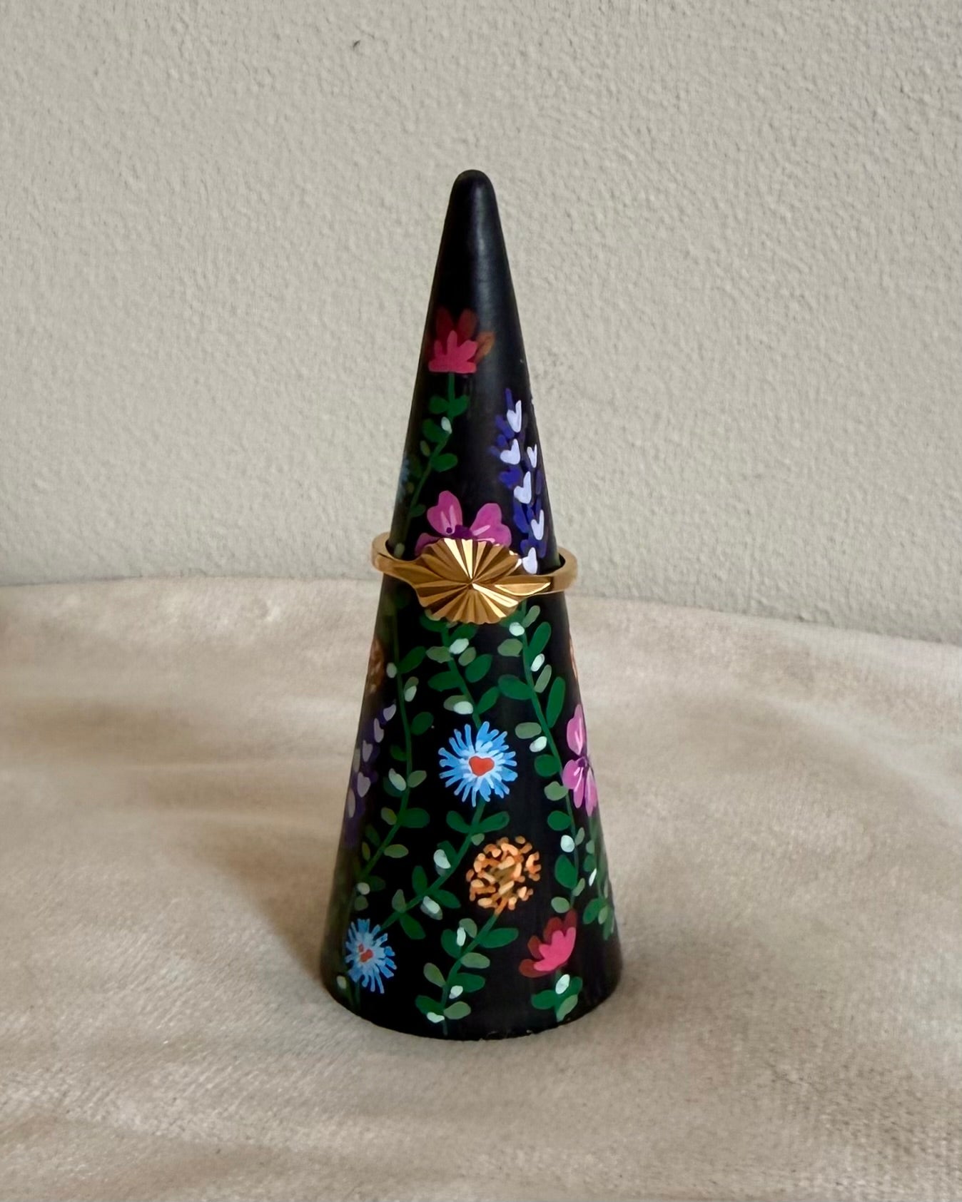 black ringcone with colorful flowers and vintage golden ring